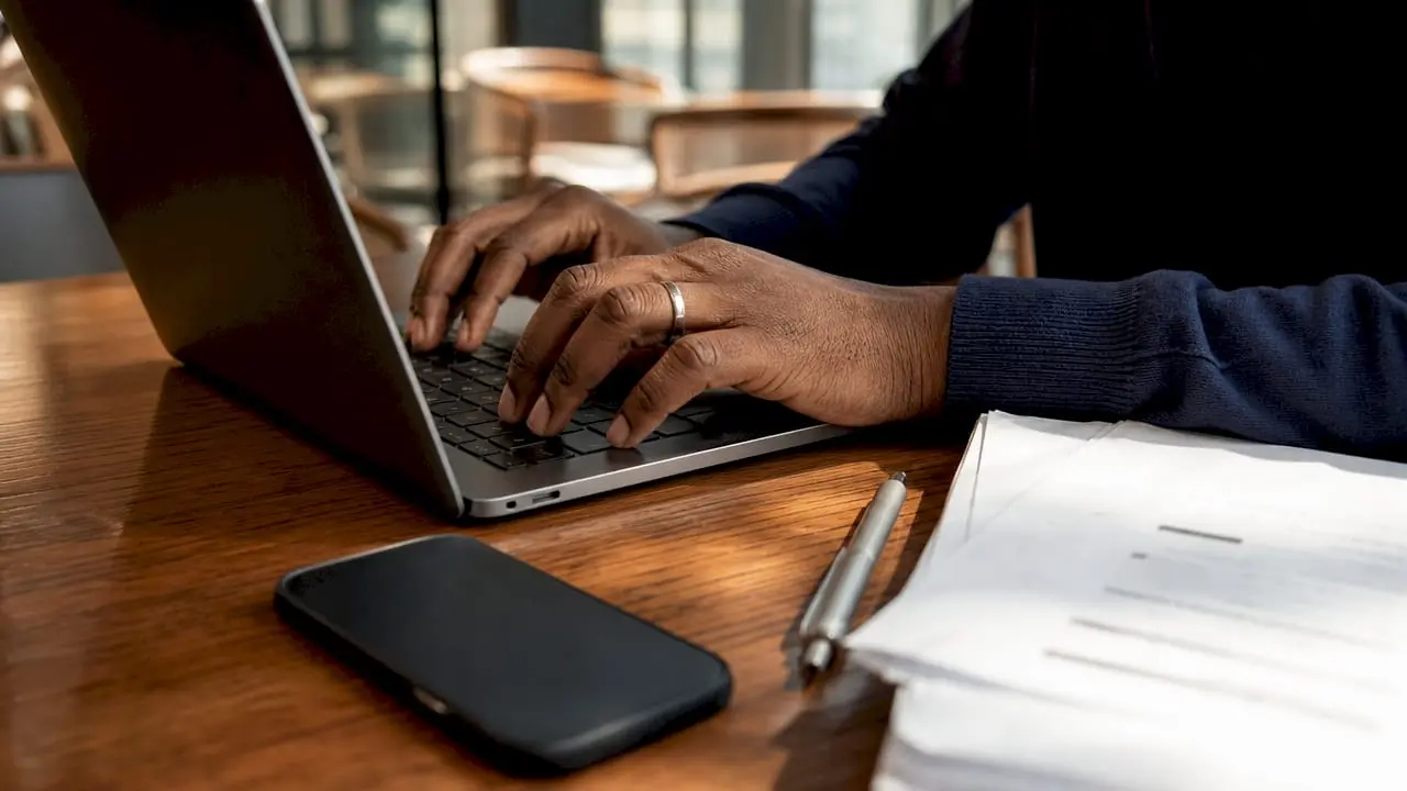 Hands typing CRM integration code on laptop