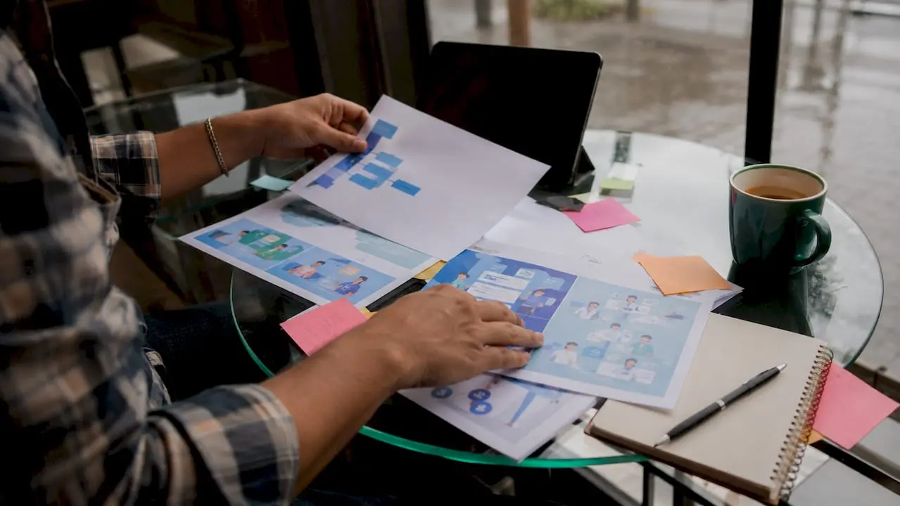 Hands organizing virtual charity event plans