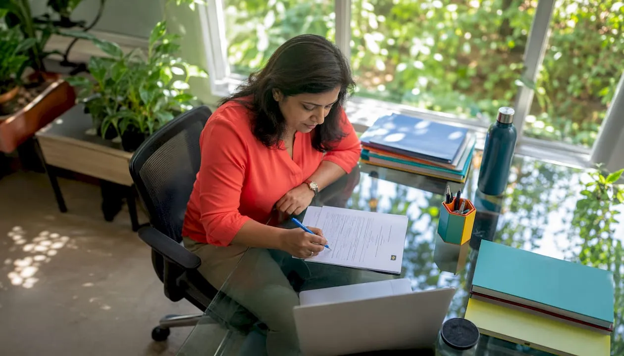 Woman filling membership form in office