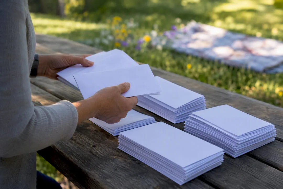 Hands sorting alumni donation envelopes