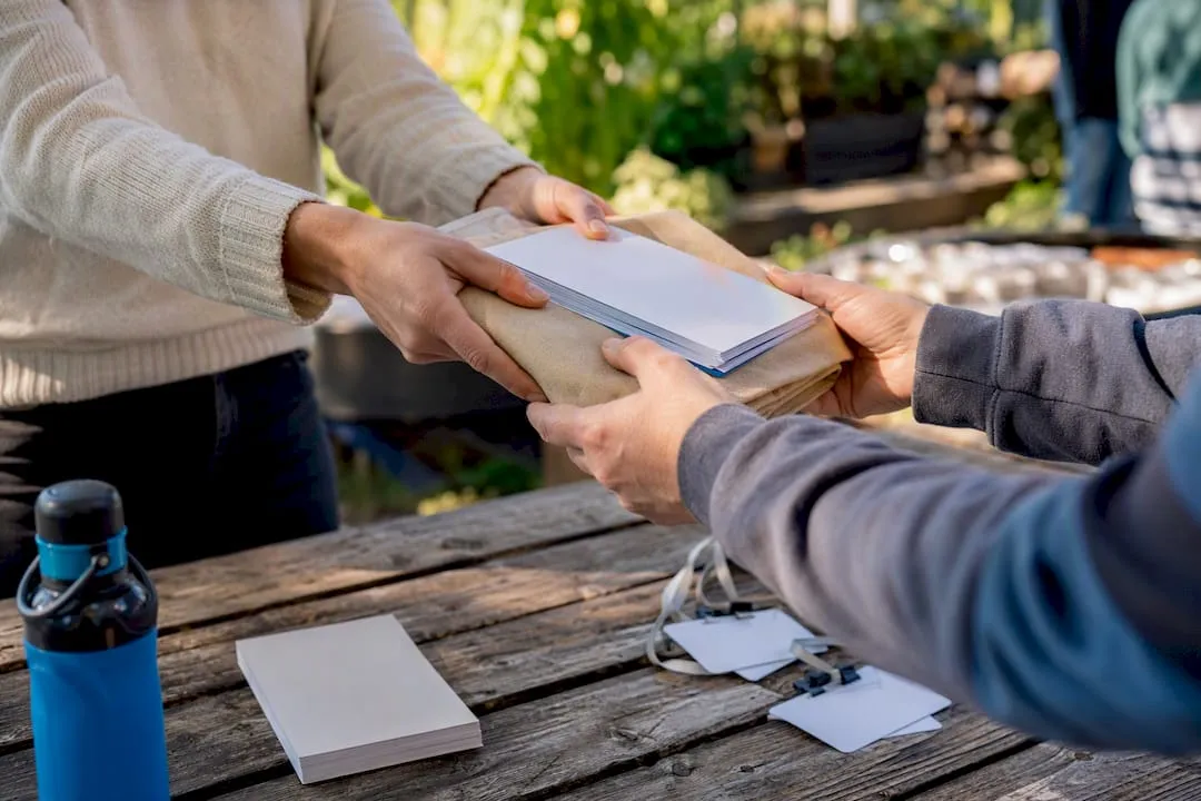 Hands exchanging welcome package in onboarding