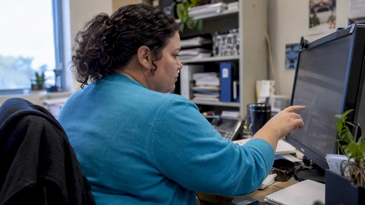 Analyst reviews student persistence indicators on screen